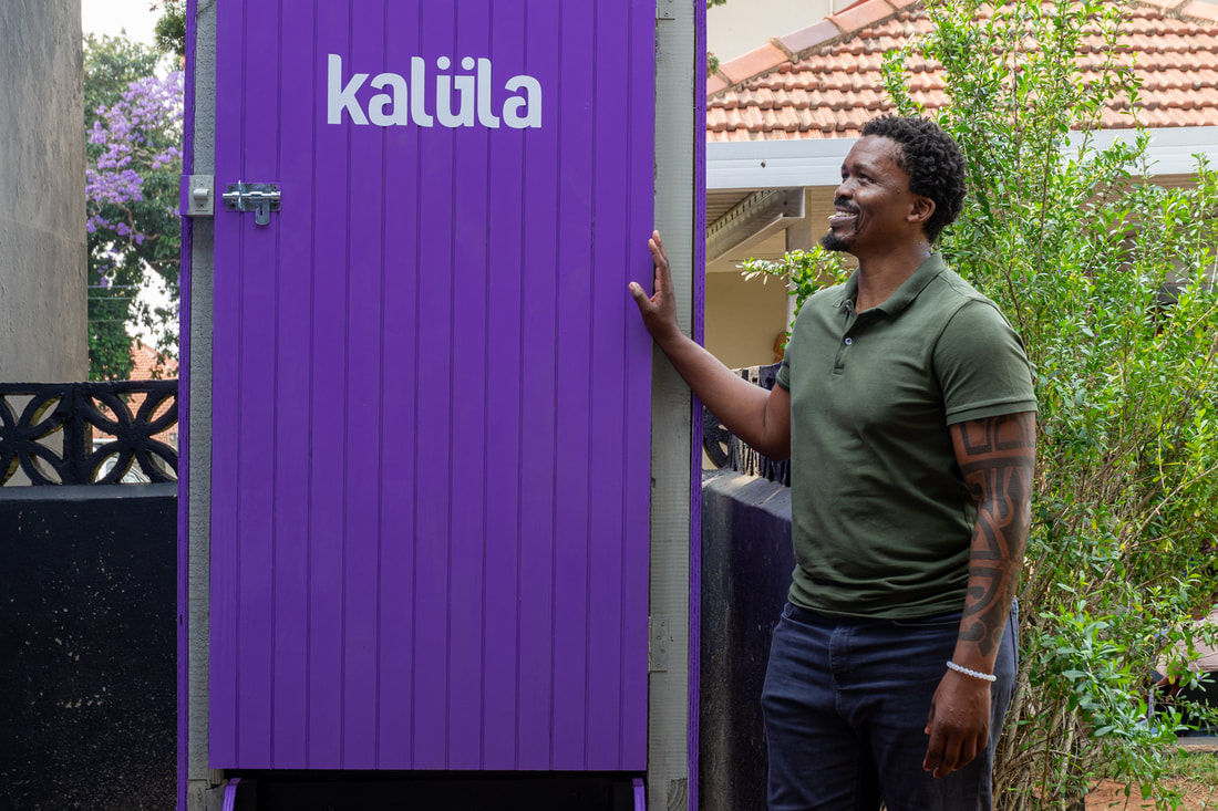 Eben Mbhele in front of a kalula toilet